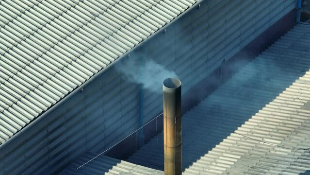 High above, industrial estates release smoke into the atmosphere, a chilling testament to the ongoing battle for cleaner air and a healthier planet. Fine Particles and Health Effects concept.  