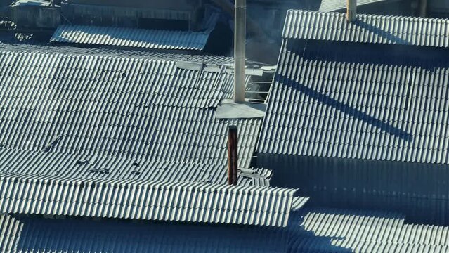From above, industrial estates spew thick smoke into the heavens, a stark visual of the ecological toll of unchecked industrialization. Air pollution and Particulate matter concept. 4K.