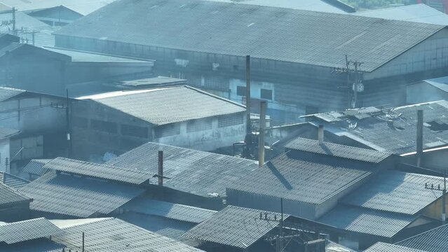 Aerial drones reveal industrial estates spewing smoke, illustrating the environmental impact of their unchecked emissions. Respiratory Illness and Environmental Hazard concept.  
