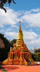 Fototapeta premium Golden Pagoda in Thakhanun temple of Kanchanaburi Province,Thailand.Thailand travel concept.Vertical.