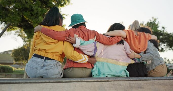 Woman, friends and hug in relax at park for love, care or support in community, trust or nature. Rear view of female group hugging sitting outside in embrace for friendship, get together or unity