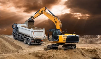 Foto op Aluminium excavator is in work and digging at construction site © Wolfilser