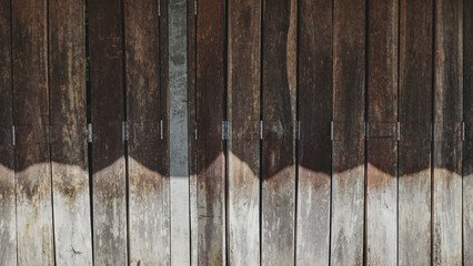 Old wooden collapsible door texture, old fashion style shutter gate.Folding old hardwood door gate,...