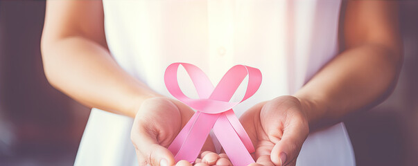 Doctor holding cancer ribon. Pink ribon breast symbol.