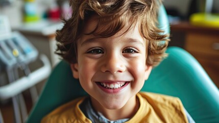 A smiling young boy in a dental chair. Dental clinic