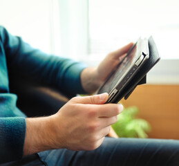 Man holding tablet computer indoors