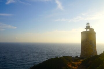 Fototapeta premium Faro de Camarinal lighthouse near Atlanterra during the sunset with a view towards the Atlantic Ocean, Costa de la Luz, Andalusia, Spain