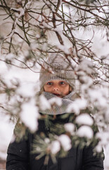 Portrait of a boy in a snowy forest