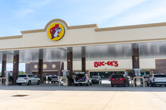 Buc-ee's convenience store and gas station in Florence, South Carolina. Exterior, gas pumps, front of store with beaver logo, yellow circle and black outline. 