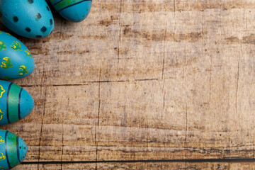 Colorful easter eggs on wooden background with copy space