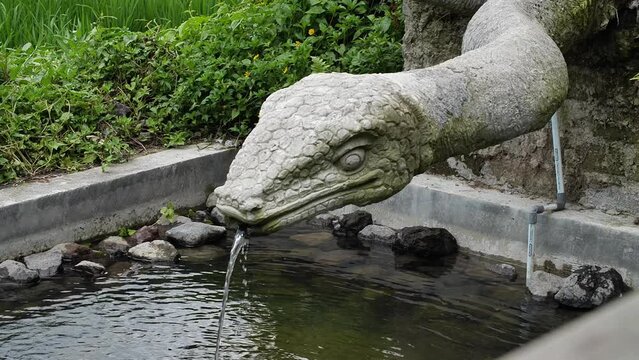 Hd slow motion footage of snake fountain statue in Monkey forest, Ubud, Bali, Indonesia.
Low angle, parallax movement.
