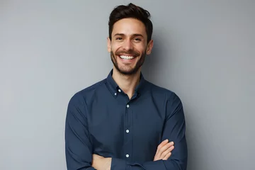 Deurstickers Handsome smiling business man in blue shirt isolated on gray background © Prasanth