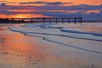 Beautiful light reflecting of a beach with a pier in the background. Saltburn-by-the-sea, North...