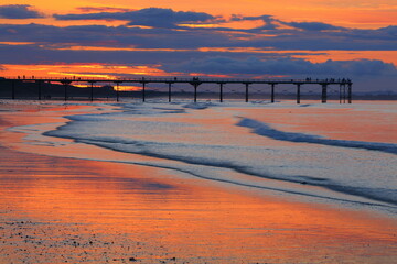 Beautiful light reflecting of a beach with a pier in the background. Saltburn-by-the-sea, North...