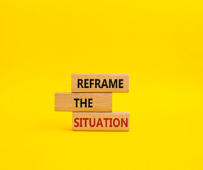 Reframe the situation symbol. Concept words Reframe the situation on wooden blocks. Beautiful yellow background. Business concept. Copy space.