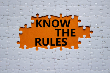 Know the rules symbol. Concept words Know the rules on white puzzle. Beautiful orange background....