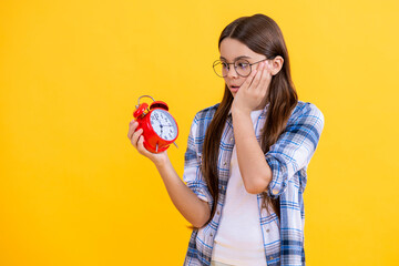 Time ticking for a busy teen girl. teen girl check time at the clock while studying. Teen girl has...