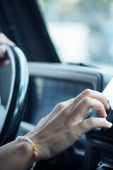 Close up of woman hand setting the gps online navigator on the phone while drive - people and...