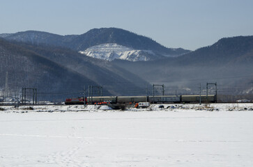 Train on snowy railroad in the mountains near Lake Baikal, Russia