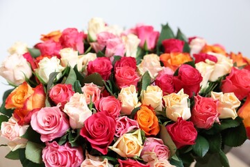 Bouquet of beautiful roses on light background, closeup