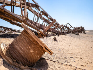 Skeleton Coast National Park, Namibia - August 21, 2022: The remnants of a rusted old oil rig tower, destroyed by the Benguela current