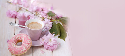 Obraz na płótnie Canvas cup with drink coffee cappuccino, hot chocolate with milk, sakura flowers, caffeine improves functioning of human brain, stimulates nervous system, health benefits and harms, copy space, banner