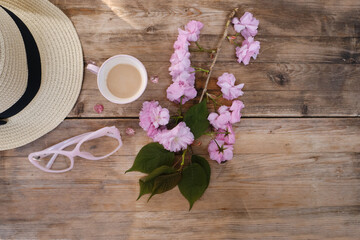cup with drink coffee cappuccino, hot chocolate with milk, light sunhat, pink sakura flowers,...