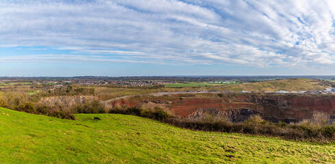 A panorama view from Croft Hill into Croft Quarry towards Huncote in Leicestershire, UK on a bright sunny day - obrazy, fototapety, plakaty