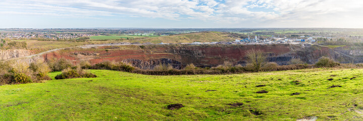A panorama view from Croft Hill across Croft Quarry in Leicestershire, UK on a bright sunny day - obrazy, fototapety, plakaty