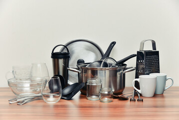 Metal and glass kitchenware on wooden table