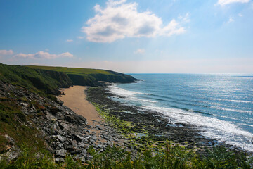 Fototapeta na wymiar The South-West Coast Path above Porthbeor Beach on the Roseland Peninsula, Cornwall, UK