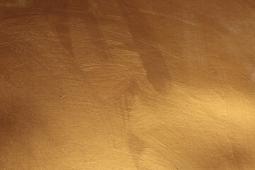 Gold ink smear brush stroke stain blot glow paper relief texture wall background.