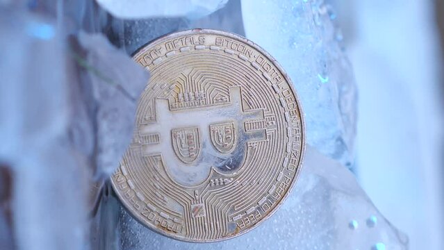 vertical video frozen bitcoin on ice burns in fire and melts ice. bitcoin growth