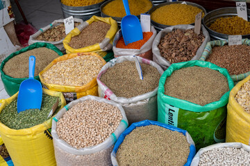 Large sacks containing legumes, beans, broad beans, chickpeas, for sale in a shop in the souk of...