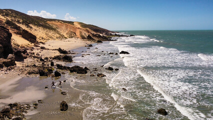 The ocean with its shades of colors in Jeriocoacoara in Brazil, the beach of Pedra Furada, the sand dunes and the long rocky coast