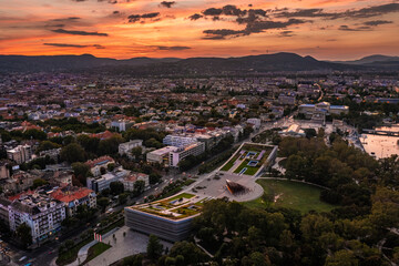 Budapest, Hungary - Aerial view of the Museum of Ethnography at City Park with Heroes' Square and skyline of Budapest at background with dramatic colorful sunset over the capital of Hungary