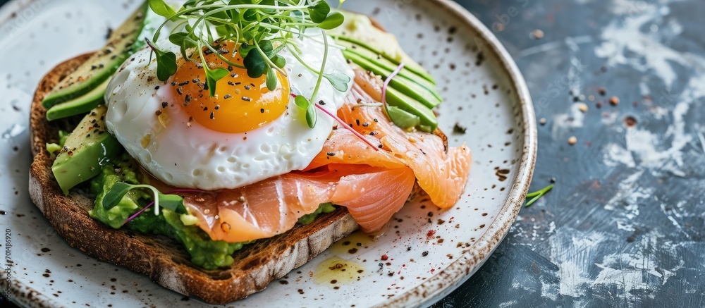 Poster toast with salmon poached egg and avocado on a white plate poached egg with salmon and guacamole on 