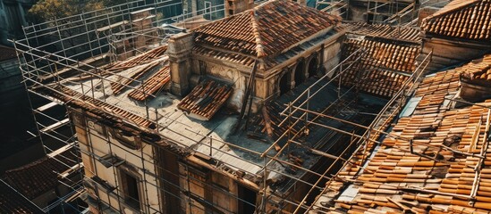 repair of historic roof under reconstruction fired stress tiles are ready in piles for laying on...