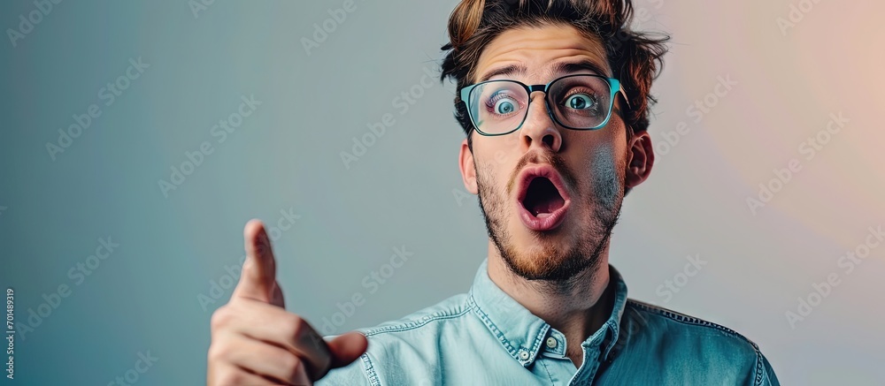 Aufkleber middle age latin man wearing casual clothes and glasses pointing with finger surprised ahead open mo