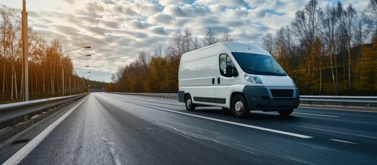 Foto op Canvas White delivery van on the highway White modern delivery small shipment cargo courier van moving fast on motorway road to city urban suburb The world s best transport of goods. Creative Banner © HN Works