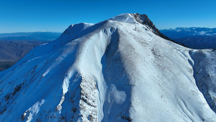 Aerial drone photo of famous ski resort of Velouchi mountain peak as seen at winter, Karpenissi,...