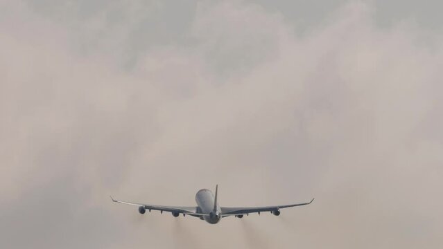 Passenger four-engine airplane take off at Phuket airport. Flight departure. Aircraft leaving, climbing. Tourism and travel concept