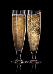 toasting with champagne glasses isolated on black background