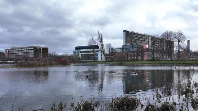 A view of Gartnavel General Hospital in the West End of Glasgow from across the neighbouring Bingham&rsquo;s pond. On a dull day with fast wind-blown clouds scudding across the sky.