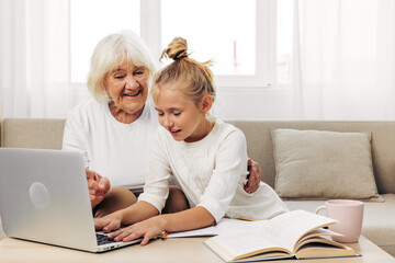 Fototapeta na wymiar Sofa family hugging child laptop togetherness grandmother bonding selfie granddaughter smiling