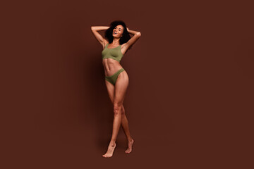 Full length no filter studio photo of shiny pretty woman wear lingerie accepting scars skin empty space isolated brown color background