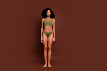 Full length no filter studio photo of confident woman wear lingerie enjoying body positive empty space isolated brown color background © deagreez