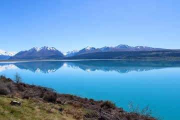 Naklejka na ściany i meble New zealand mirror lake blue and mountains in the back brown in the front