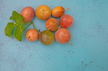 Fresh, organic passiflora berries on a blue background.