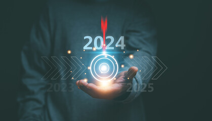 2024 business planning and strategy to target concept, Businessman holds business target symbol for...